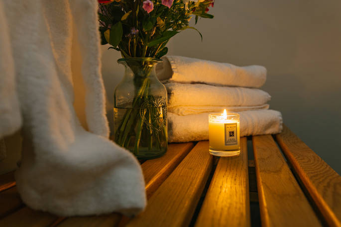 Candle and fluffy towels at Penhein Glamping in Monmouthshire