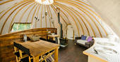 The fully-equipped kitchen and dining area inside The Oakes tent at Penhein Glamping
