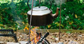 Kettle boiling on an open fire at Penhein Glamping in Monmouthshire