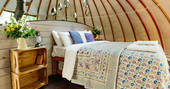 The comfortable kingsize bed inside The Oakes tent at Penhein Glamping in Monmouthshire
