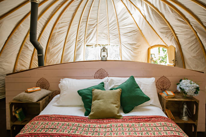 The comfortable kingsize bed inside The Park tent at Penhein Glamping in Monmouthshire
