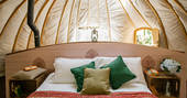 The comfortable kingsize bed inside The Park tent at Penhein Glamping in Monmouthshire