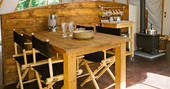 The kitchen and dining area inside The Park tent at Penhein Glamping in Monmouthshire
