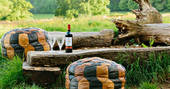 Relax on the comfy beanbags and enjoy a glass of wine al fresco at Penhein Glamping in Monmouthshire