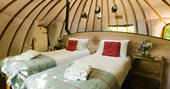 Comfortable twin beds inside The Park tent at Penhein Glamping in Monmouthshire