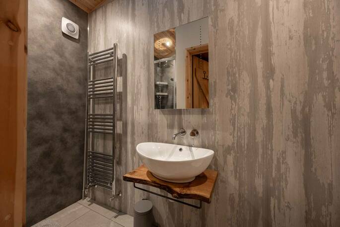 Bathroom with a hot shower, sink, flushing toilet