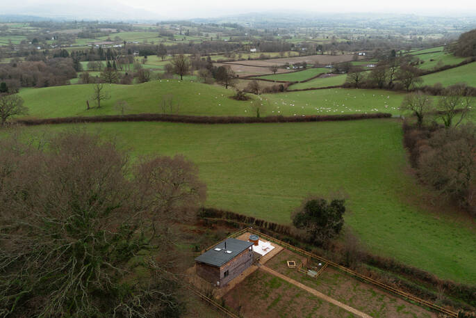 Cabin looks over rolling hills