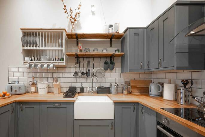 Kitchen equipped with an induction hob, oven, kettle, toaster and cooking utensils