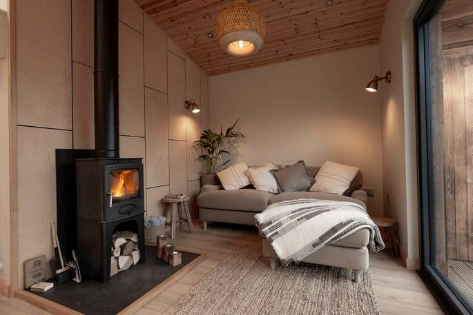 Living area with a sofa and wood burner