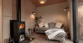 Living area with a sofa and wood burner