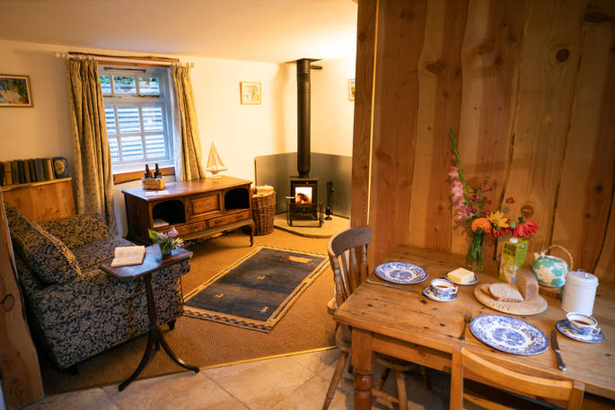 Brambling Cross cabin interior with wood burner, The Hop Garden at Kingstone Brewery, Tintern, Monmouthshire, Wales