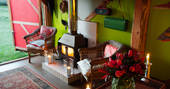 A roaring log burner, the perfect cosy spot at Stripy Bothy, Monmouthsire in Wales