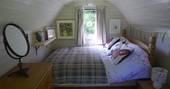 The comfortable and cosy double bed in the glamping pod at Cwt Gwyrdd