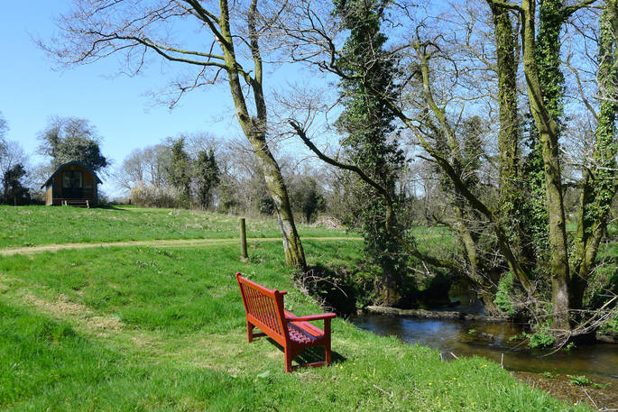 Relax on the bench by the stream at Cwt Gwyrdd in Pembrokeshire