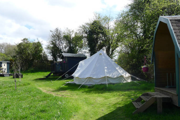 All the spaces at Cwt Gwrydd camp, which includes a shepherd's hut, bell tent and pod