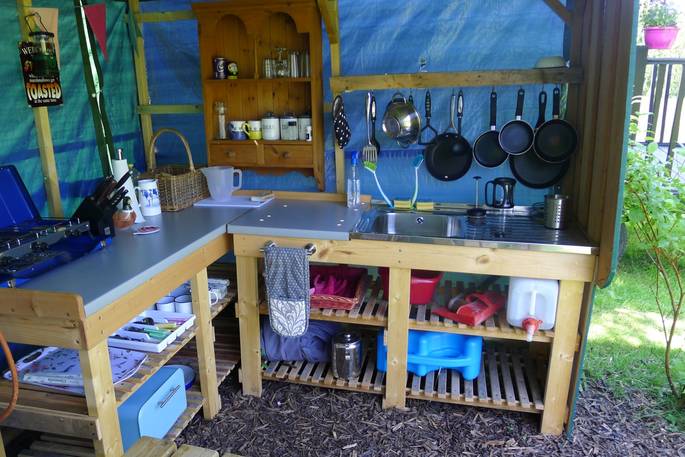 Cook up a feast in the outdoor camp kitchen at Cwt Gwyrdd