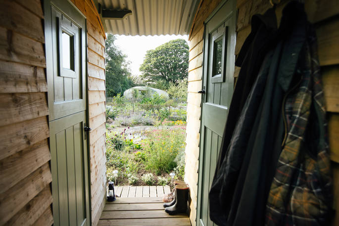 adjoining shepherd's huts wales garden view