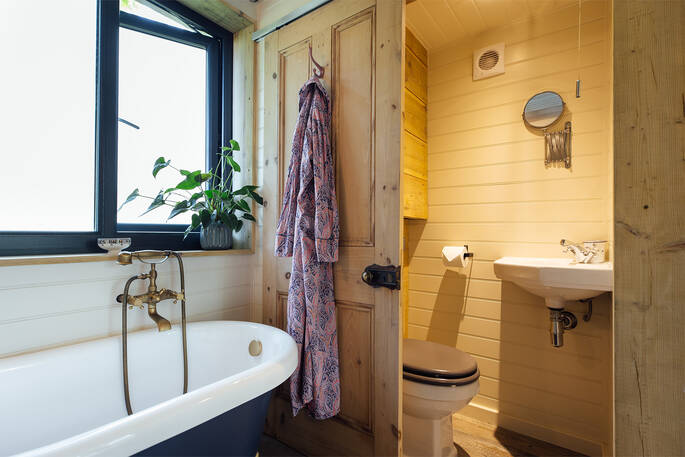 Bathroom with a flushing toilet and sink