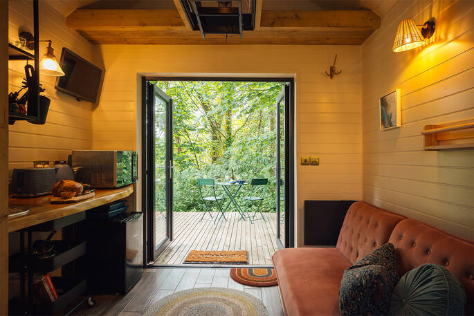 Open plan area with a kitchenette and sofa