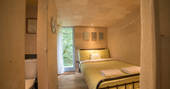 Bedroom area inside of Beudy Banc treehouse with double bed and en suite in Powys 