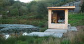 Exterior of Caban Cilfa by the pond at Beudy Banc in Wales