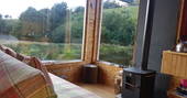 Interior of seating area and wood-burner at Caban Cilfa in Powys 