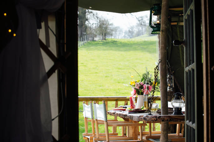 Looking outside from the Jericho Yurt with a green view and bunch of flowers.