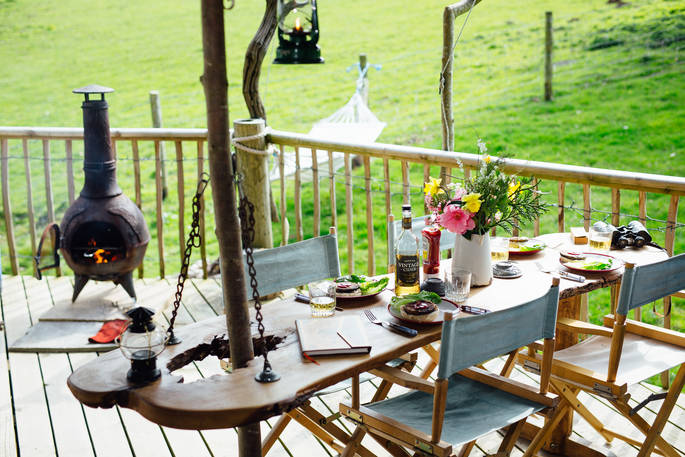 The outdoor eating area prepped for dinner at Jericho Yurt with a warming log burner.