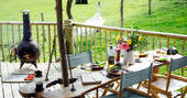 The outdoor eating area prepped for dinner at Jericho Yurt with a warming log burner.
