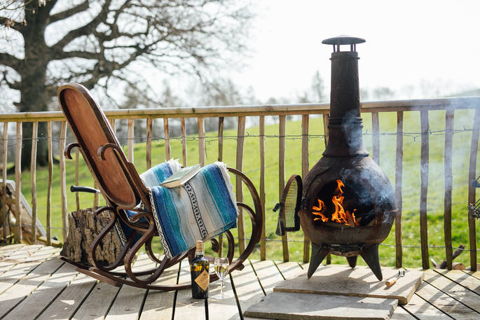 The rustic seating area with a log burner to keep you warm at Jericho Yurt, Powys in Wales.
