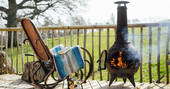 The rustic seating area with a log burner to keep you warm at Jericho Yurt, Powys in Wales.