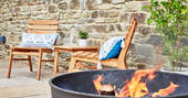 Enjoy the outdoors next to the roaring fire pit at The Burrow in Powys