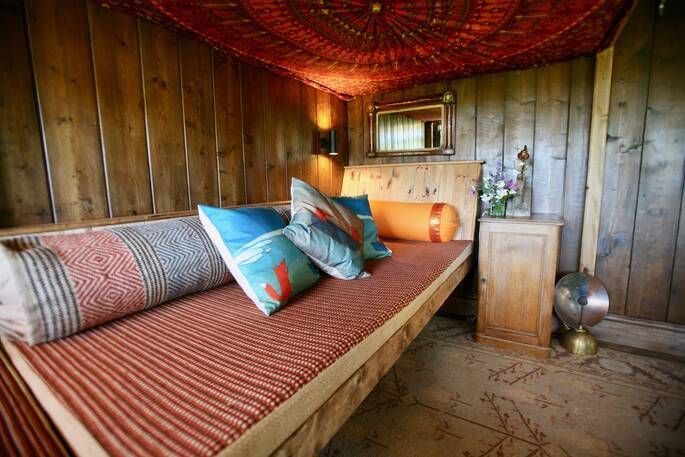 Cosy sofa bed/seating area underneath the double bed inside of The Duck Hut cabin 