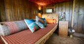 Cosy sofa bed/seating area underneath the double bed inside of The Duck Hut cabin 