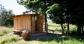 Exterior of the wooden shower shack for the Duck Hut cabin in Powys 