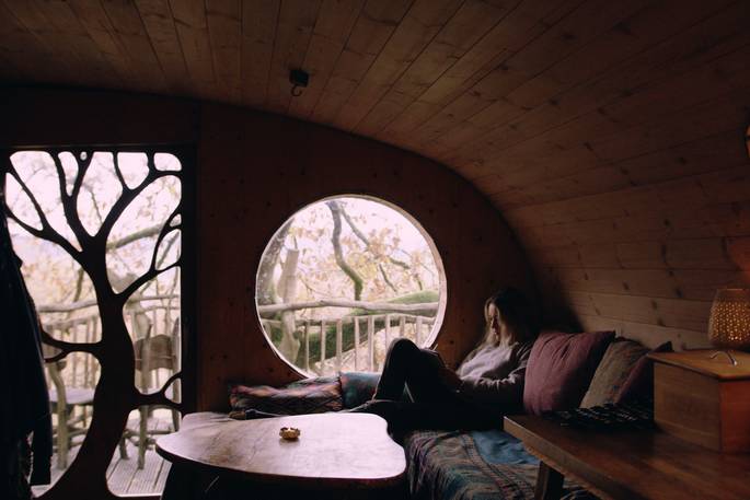A view of the cosy wood-clad interiors at Gwdy Hw treehouse in Wales