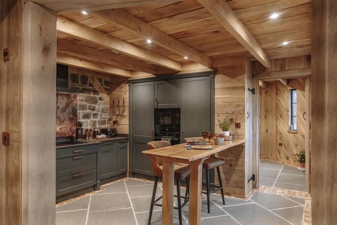 Open plan kitchen equipped with an oven, stove, and full fridge