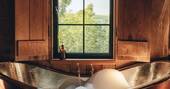 Freestanding bath tub in bedroom