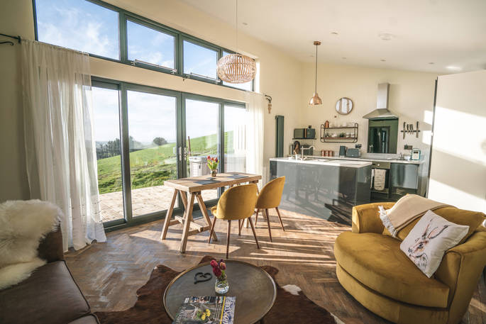 Open plan kitchen and living room area inside Shepherds Hill at Penlan Farm in Powys