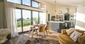Open plan kitchen and living room area inside Shepherds Hill at Penlan Farm in Powys