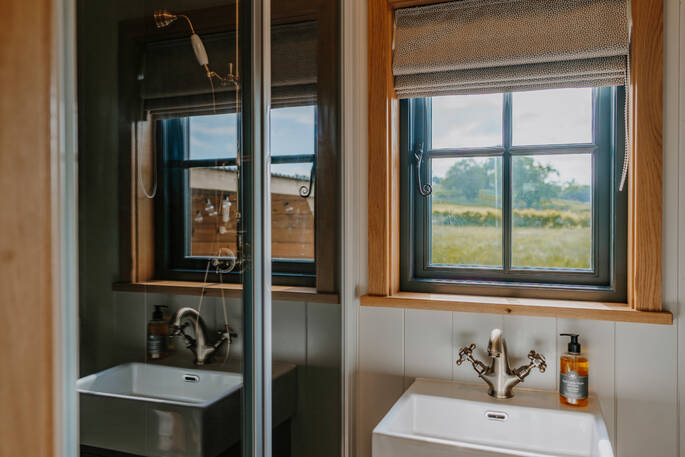 Bathroom with shower, flushing toilet and sink