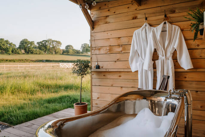 Outdoor bathtub and bath robes provided