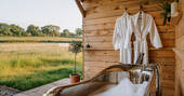 Outdoor bathtub and bath robes provided