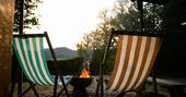 Two deckchairs by the cosy firepit overlooking the stunning Powys countryside, at The Sleepout Sunnylea