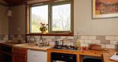 Kitchen equipped with a hob, oven and undercounter fridge