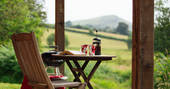 Sip your cup of coffee with views of the wood and mountains at The Straw Cottage in Powys, Wales
