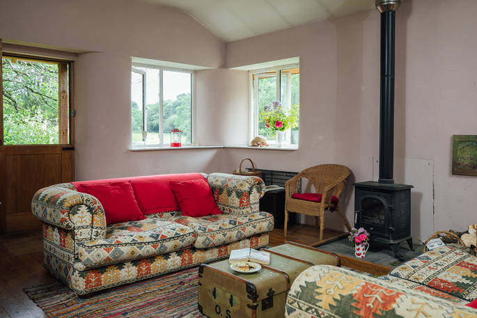 The bright and colourful living space at the Straw Cottage in Powys, where you can leave the windows open and let the fresh air blow in