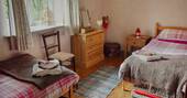 The cosy bedroom, perfect for a family at The Straw Cottage in Powys, Wales