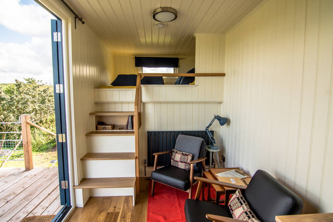 Interior of Pantechnicon Powys truck with stairs leading up to the king-size bed at Welsh Lavender 