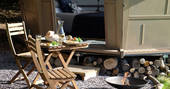 Dine al fresco and bring your food outside sitting by the campfire at St Donats 
